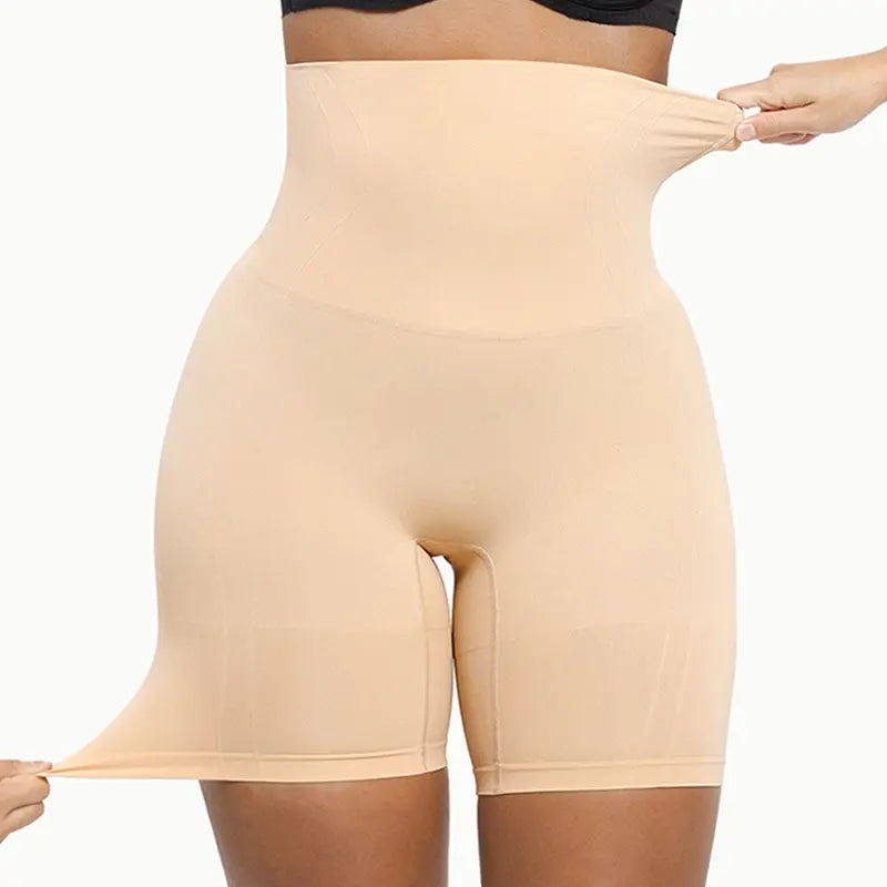 Woman wearing nude high-waist seamless shaping shorts showing stretch