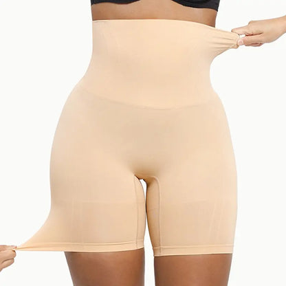 Woman wearing nude high-waist seamless shaping shorts showing stretch